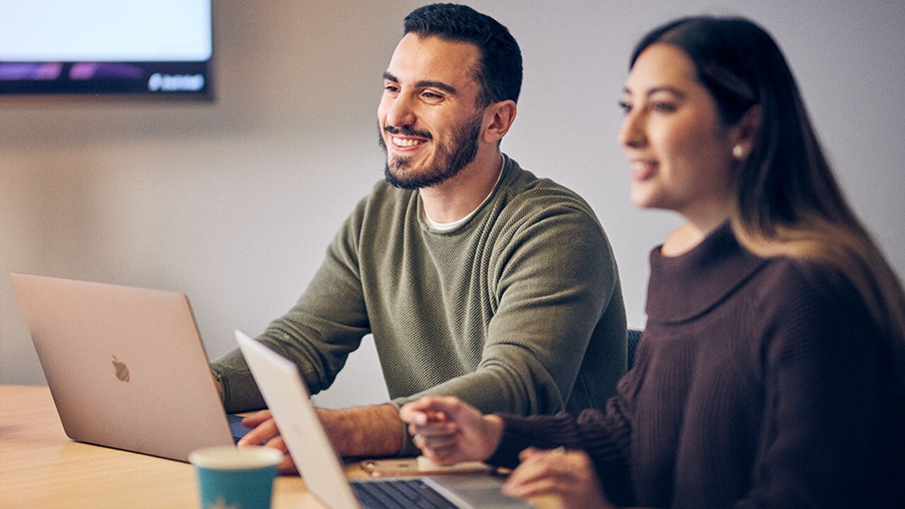 Two employees working together on a project.