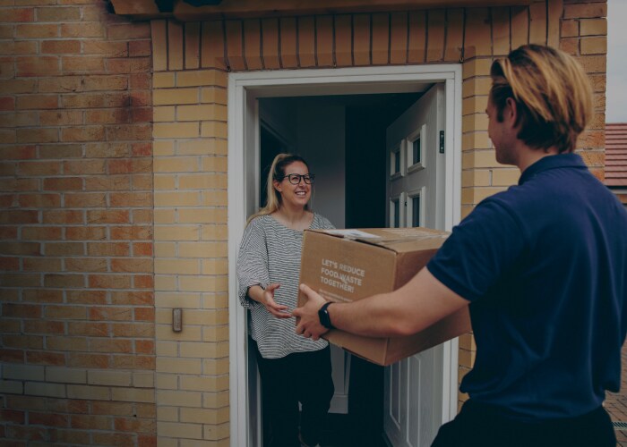 Male delivering a shipment to a female