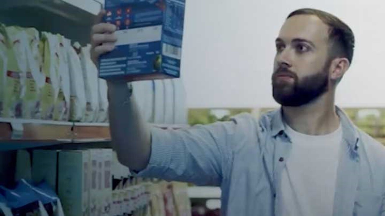 A make customer checking out products at a retail supermarket