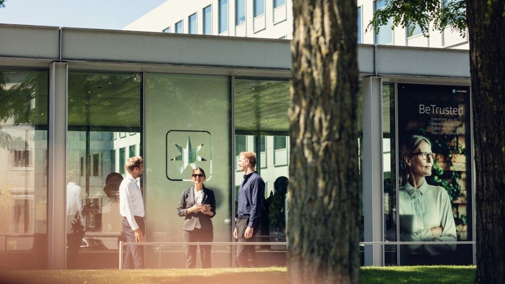 Maersk office with people standing outside and discussing