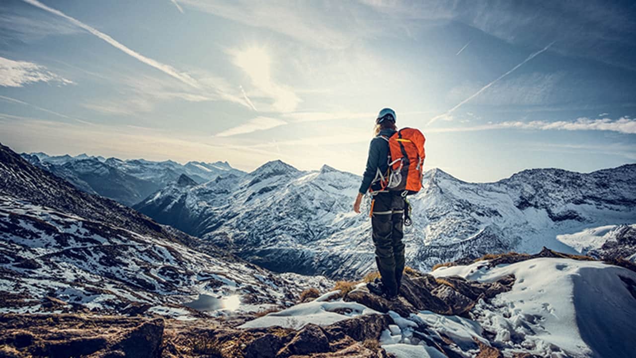 A man stands at the mountain, gazing upon it.