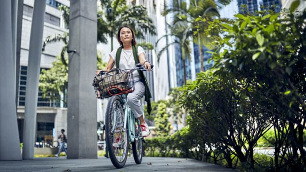 A woman riding bike in the office premises.