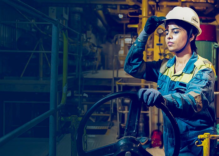 Women employee wearing blue jacket and white hat