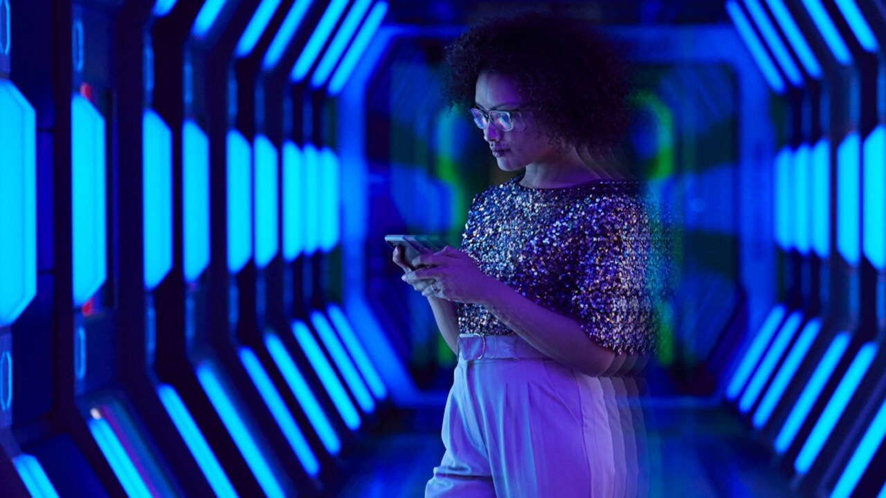 woman on phone in dark hallway