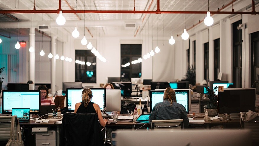 Office with people working at their computers working with digital customs.