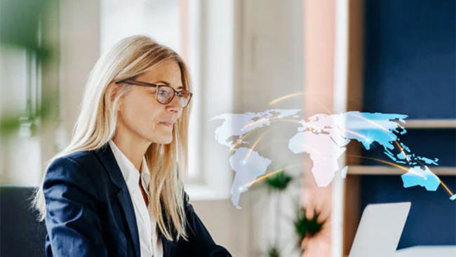 Women watching globe map