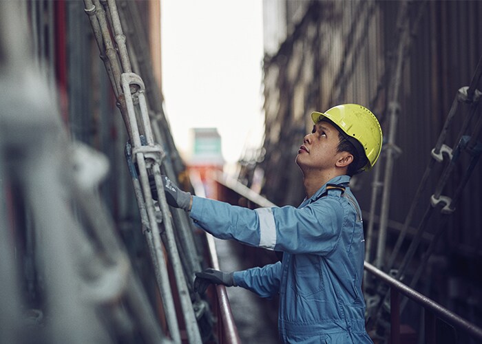 Male wearing a protective gear working on a dockyard