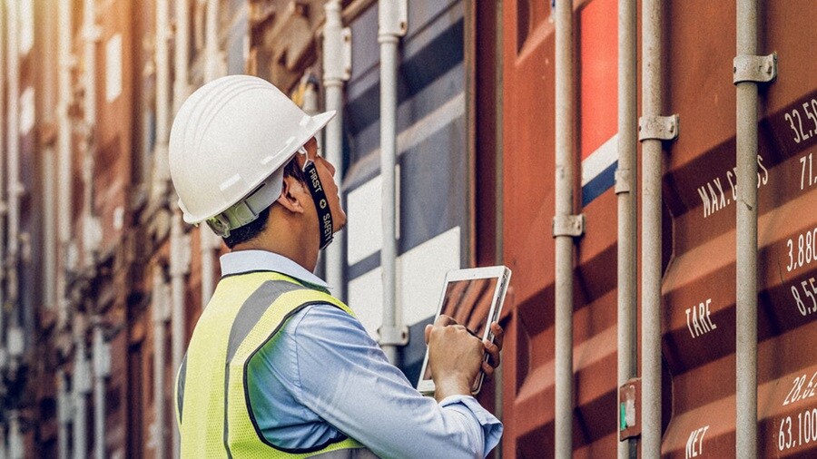 Stock of inspector checking information on containers