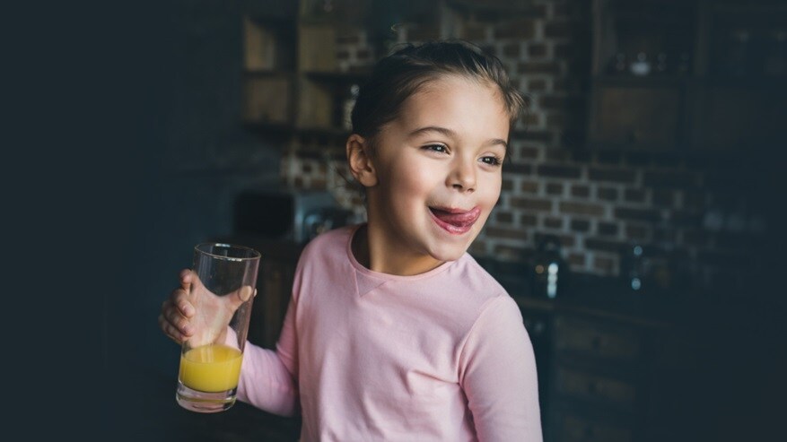 Girl holding a glass with juice