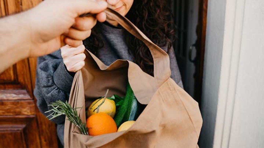 brown groceries bag delivered to a customer’s doorstep