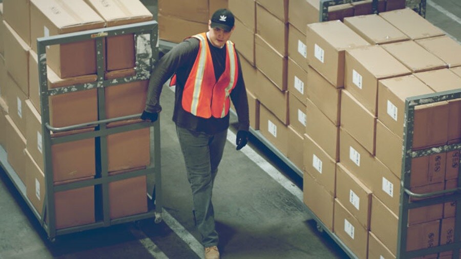 Man at warehouse moving boxes