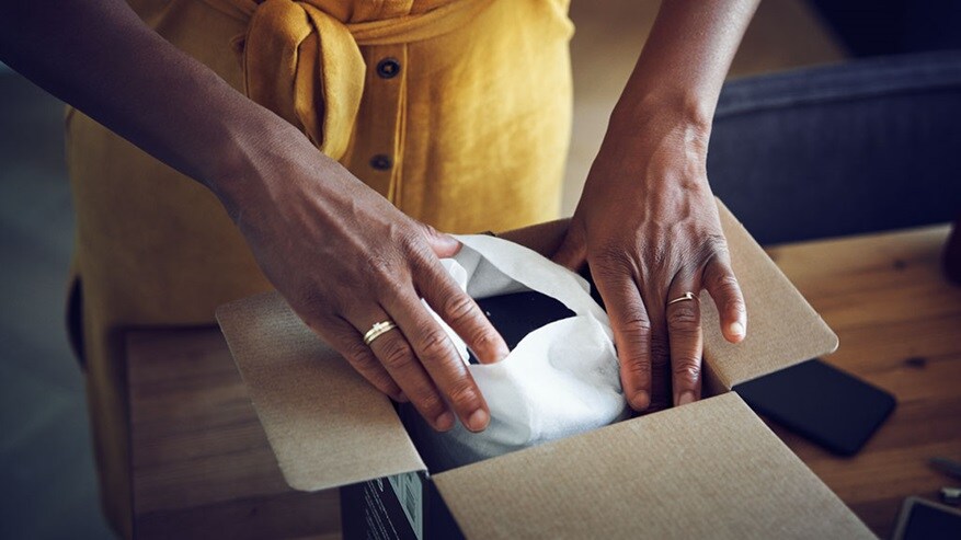 Woman hands opening a package with a new purchase