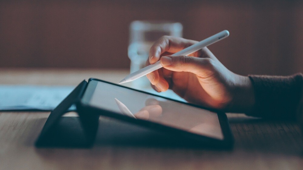 Close-up of a hand accessing Customs Trade Digital Solutions on their tablet