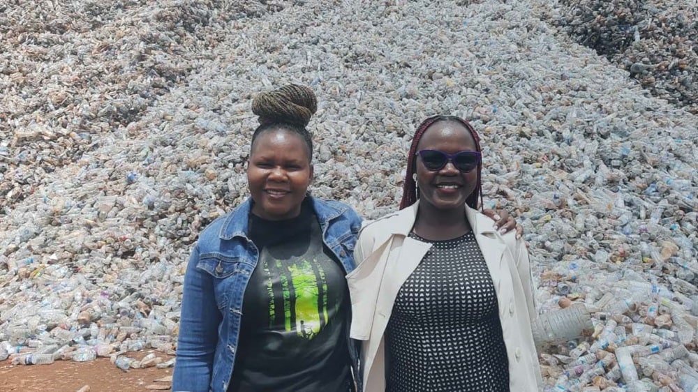 Two person posing before plastic recycling