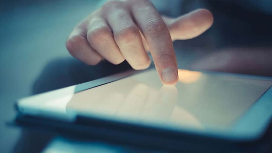 Person pointing on digital tablet screen