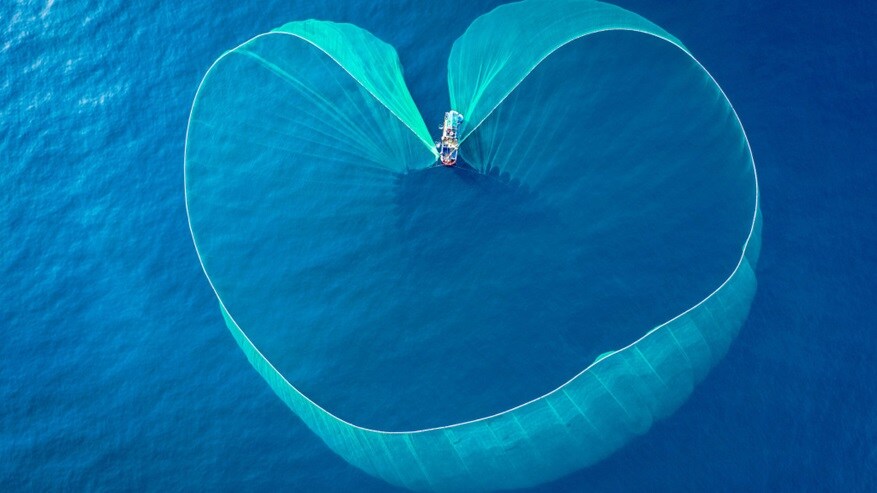 A huge fishing net thrown in the blue ocean