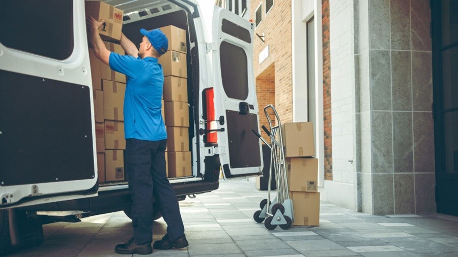 Male loading shipments in a white van