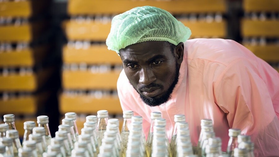 Man looking glass bottles