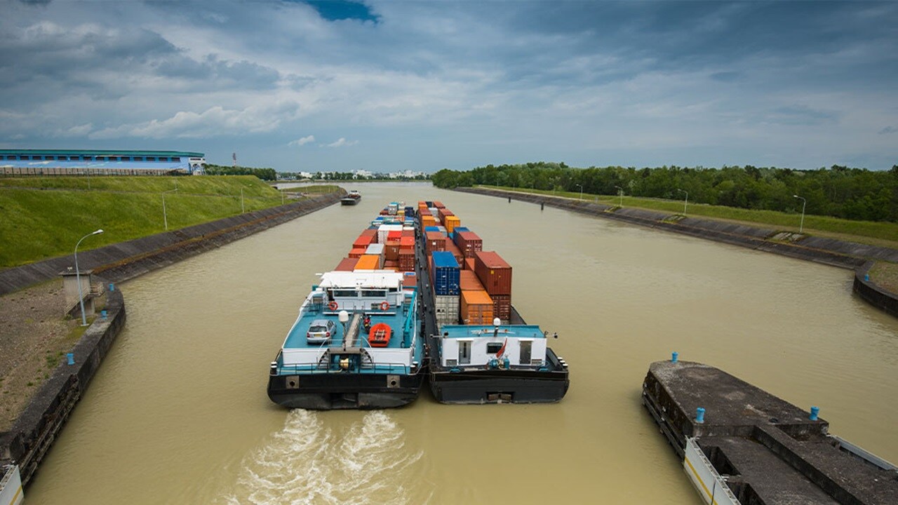 Container barges sailing through canal