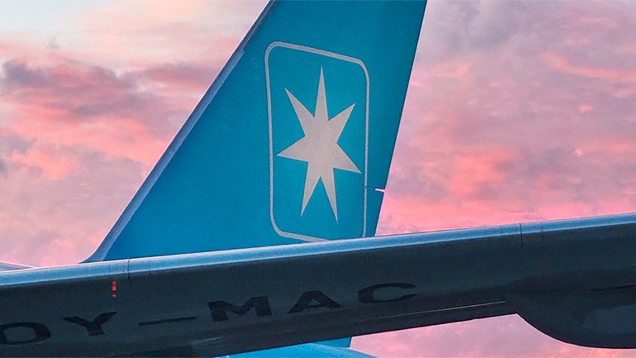 An airplane tail with a blue background.
