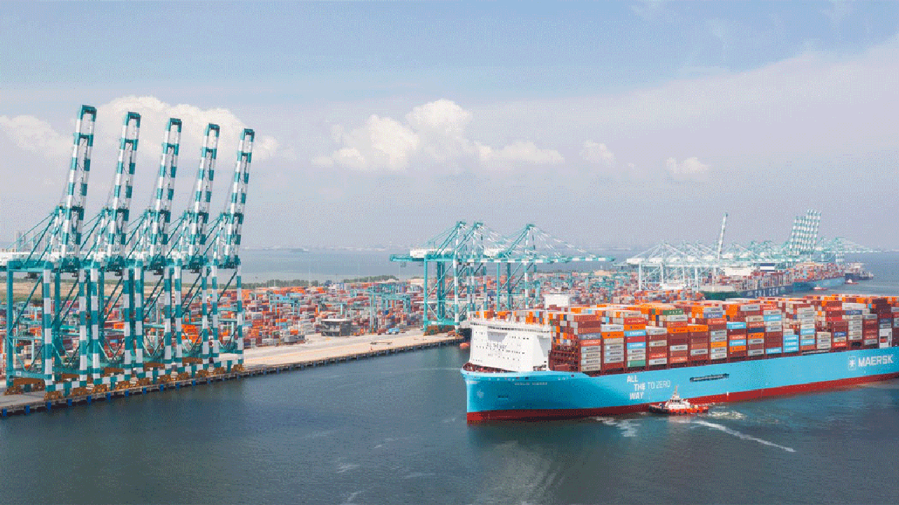 A bustling port scene with Maersk containers being loaded, representing the growth and activity in their container operations.