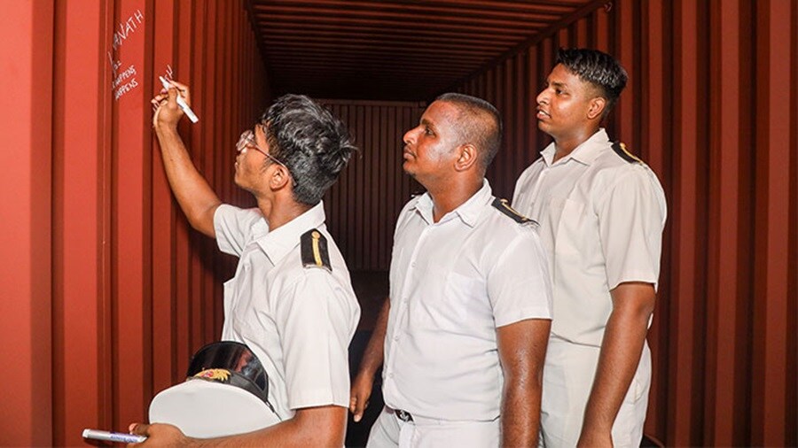 Cadets signing inside the rainbow container