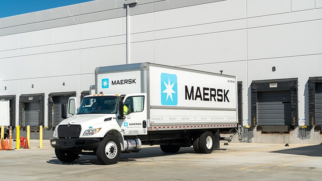 Maersk truck parked at warehouse loading docks for cargo operations