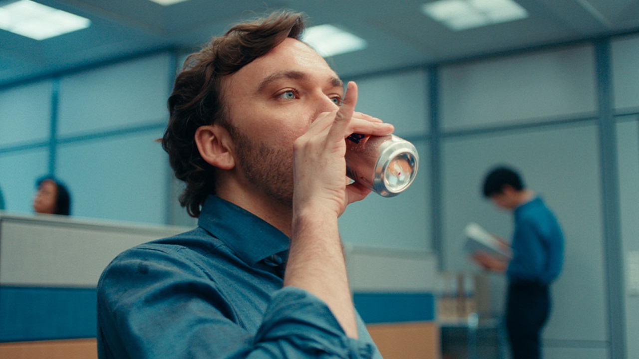Business professional drinking from a can of juice.