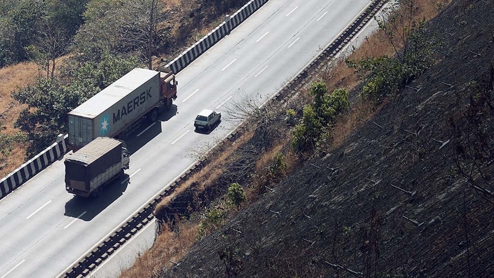 Truck carrying a Maersk container is engaged in road cargo transport.